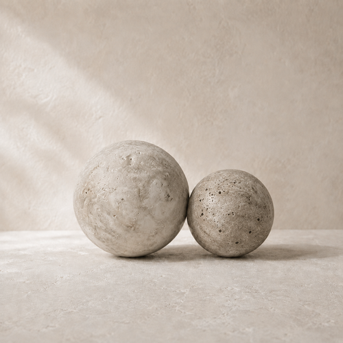 The Newel, a pair of silver-grey travertine spheres by Lomāe, slightly different in size