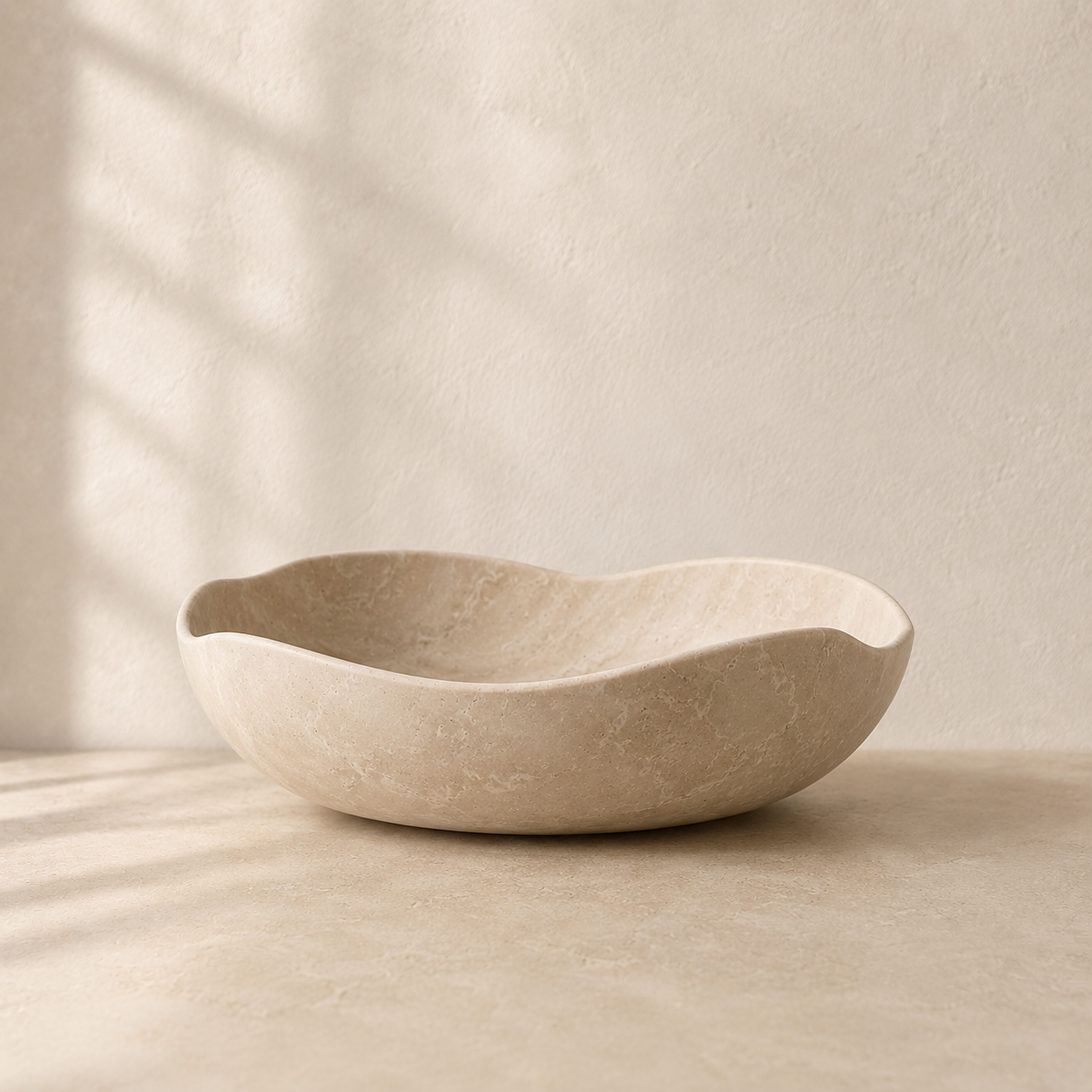 The Waitākere, a cream marble bowl by Lomāe, twenty-three centimetres across with an organic curve