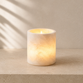 The Vesper, a Spanish alabaster tea light cylinder by Lomāe, glowing softly in low evening light